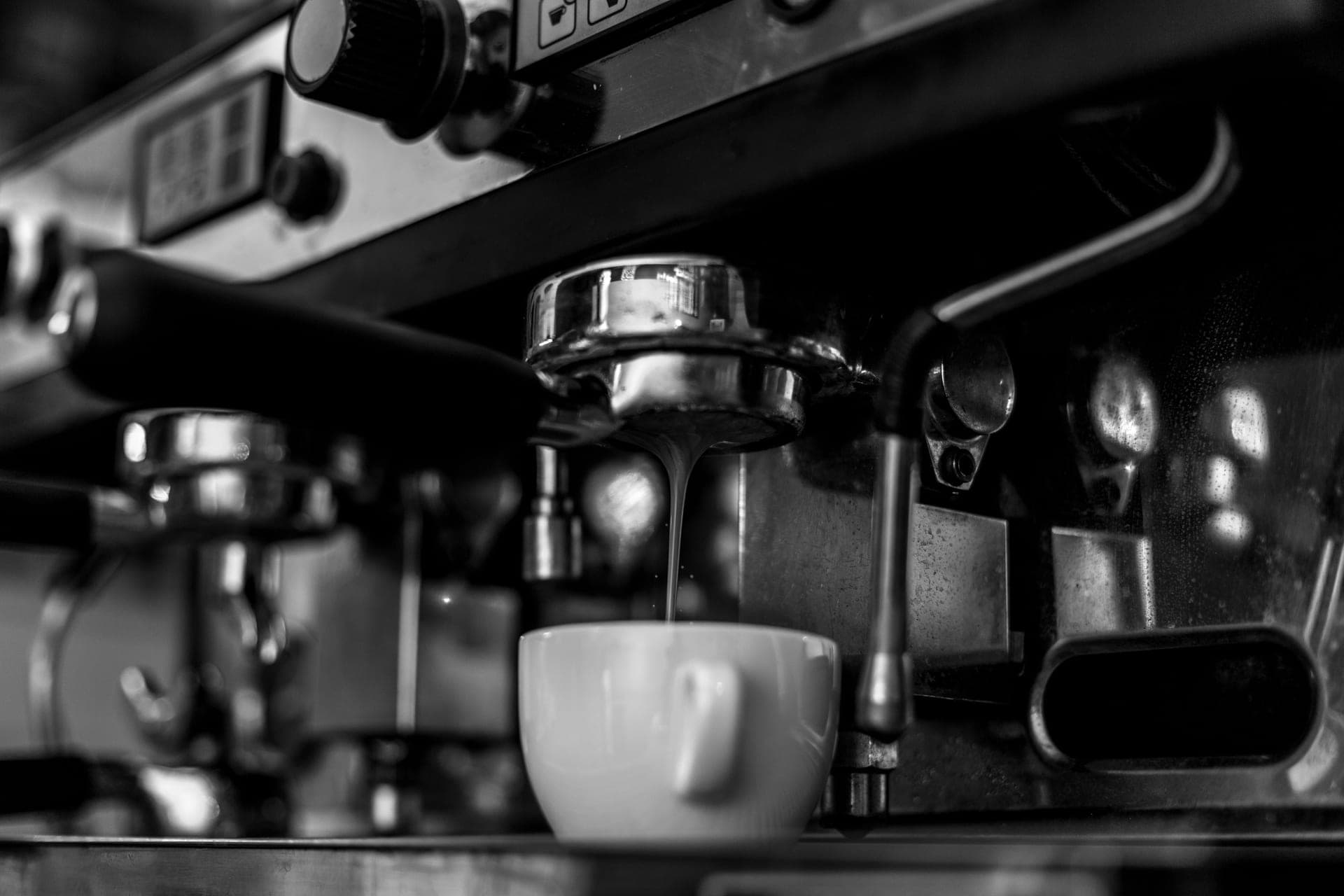 A drip coffee maker brewing into a glass carafe on a counter