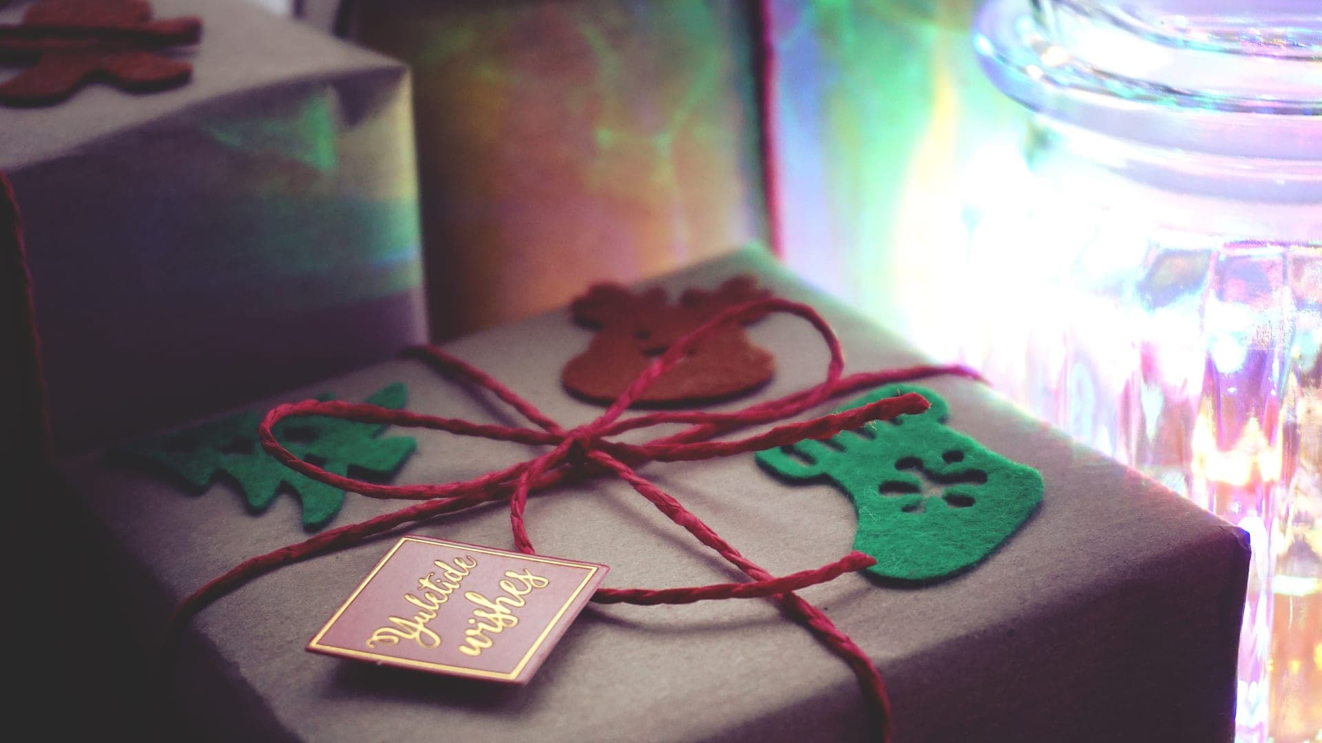 A wrapped gift beside coffee beans and a cup